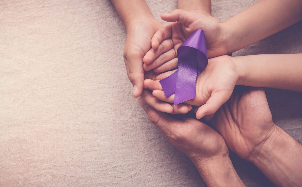 Adult and child hands holding purple ribbon, Alzheimer’s disease, Pancreatic cancer, Epilepsy awareness, world cancer day