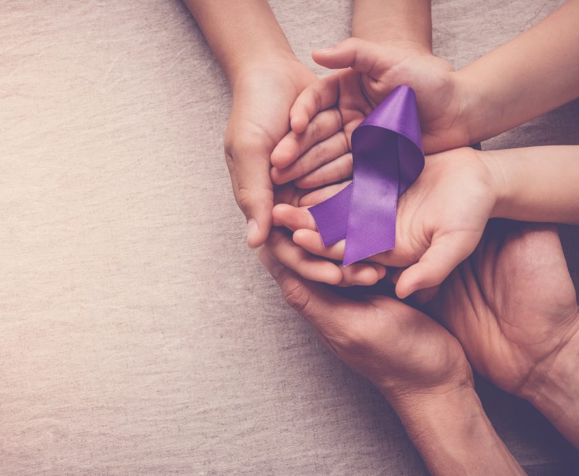 Adult and child hands holding purple ribbon, Alzheimer’s disease, Pancreatic cancer, Epilepsy awareness, world cancer day